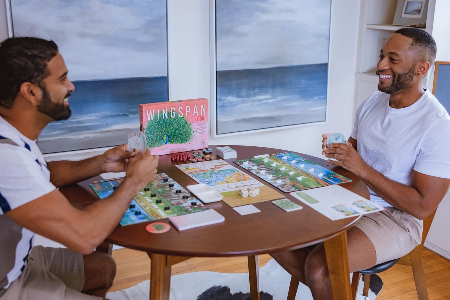 two people playing Wingspan Asia around a round table
