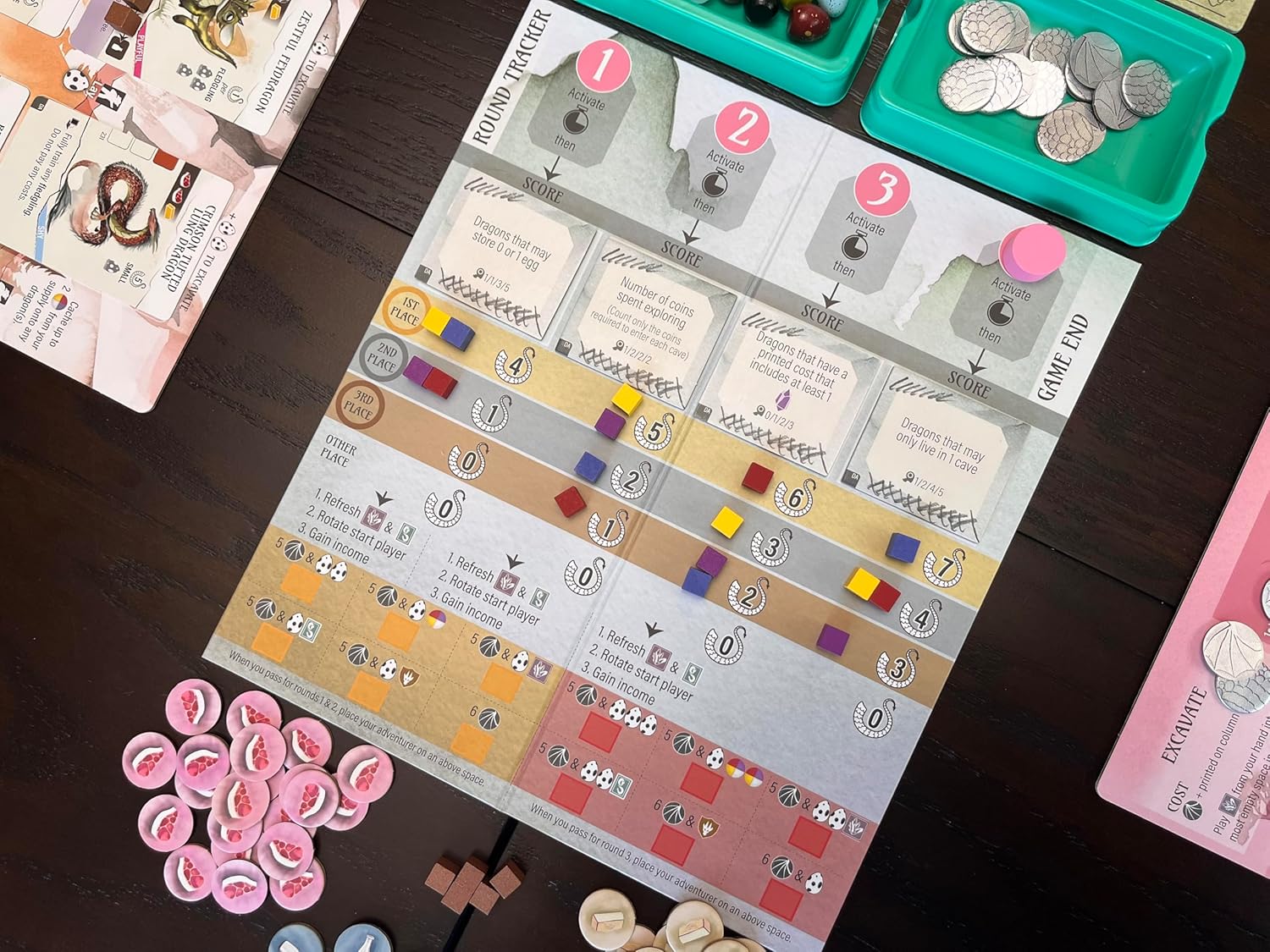 Board game setup with components on a wooden surface
