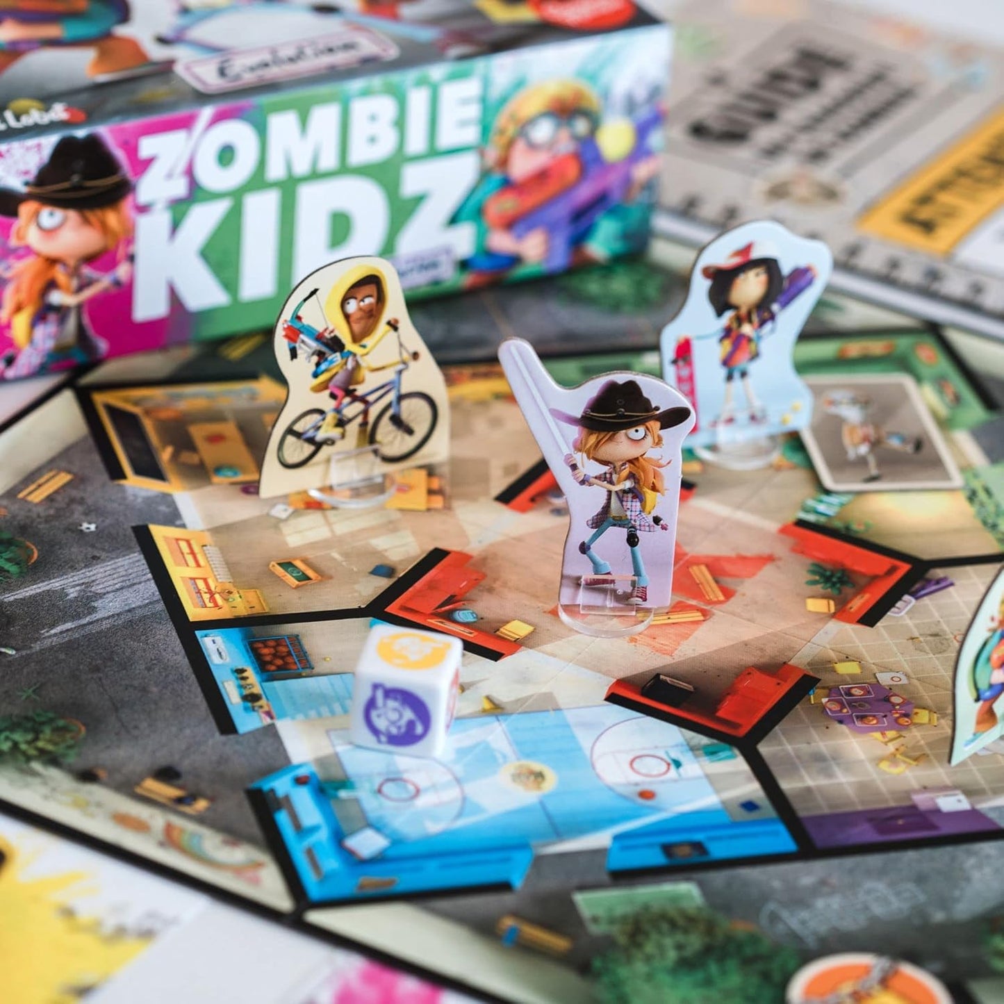 Board game with character figures and 'Zombie Kidz' box in the background